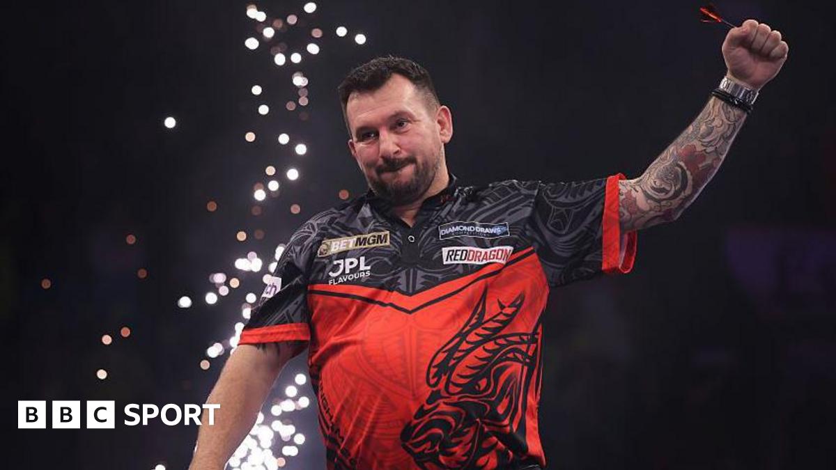 Jonny Clayton celebrates with his arm in the air after winning Premier League darts night six in Nottingham