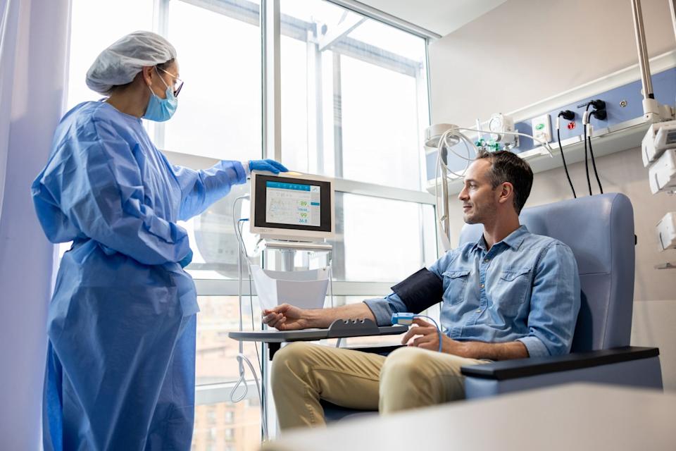 A person in a hospital getting their blood pressure checked. 