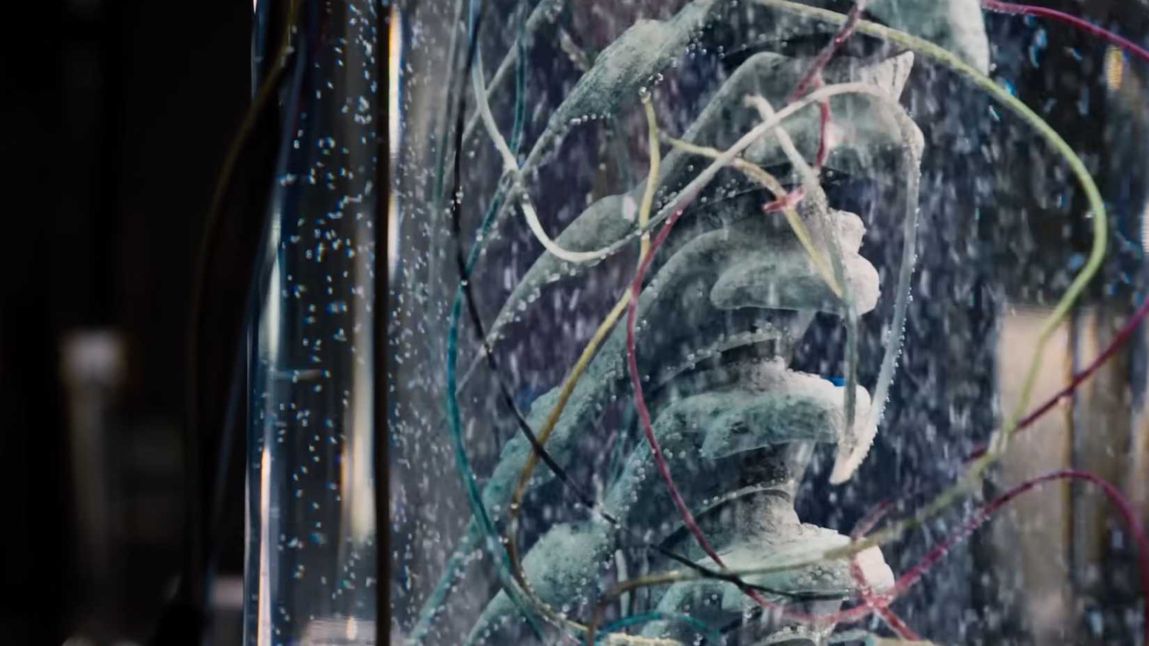 Dinosaur bones in a test tube covered in wires in Jurassic Park Fallen Kingdom
