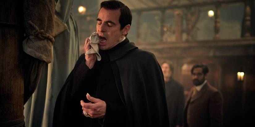 Claes Bang holding a cloth up to his mouth in 'Dracula.'