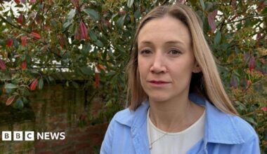 Laura stands in her garden.