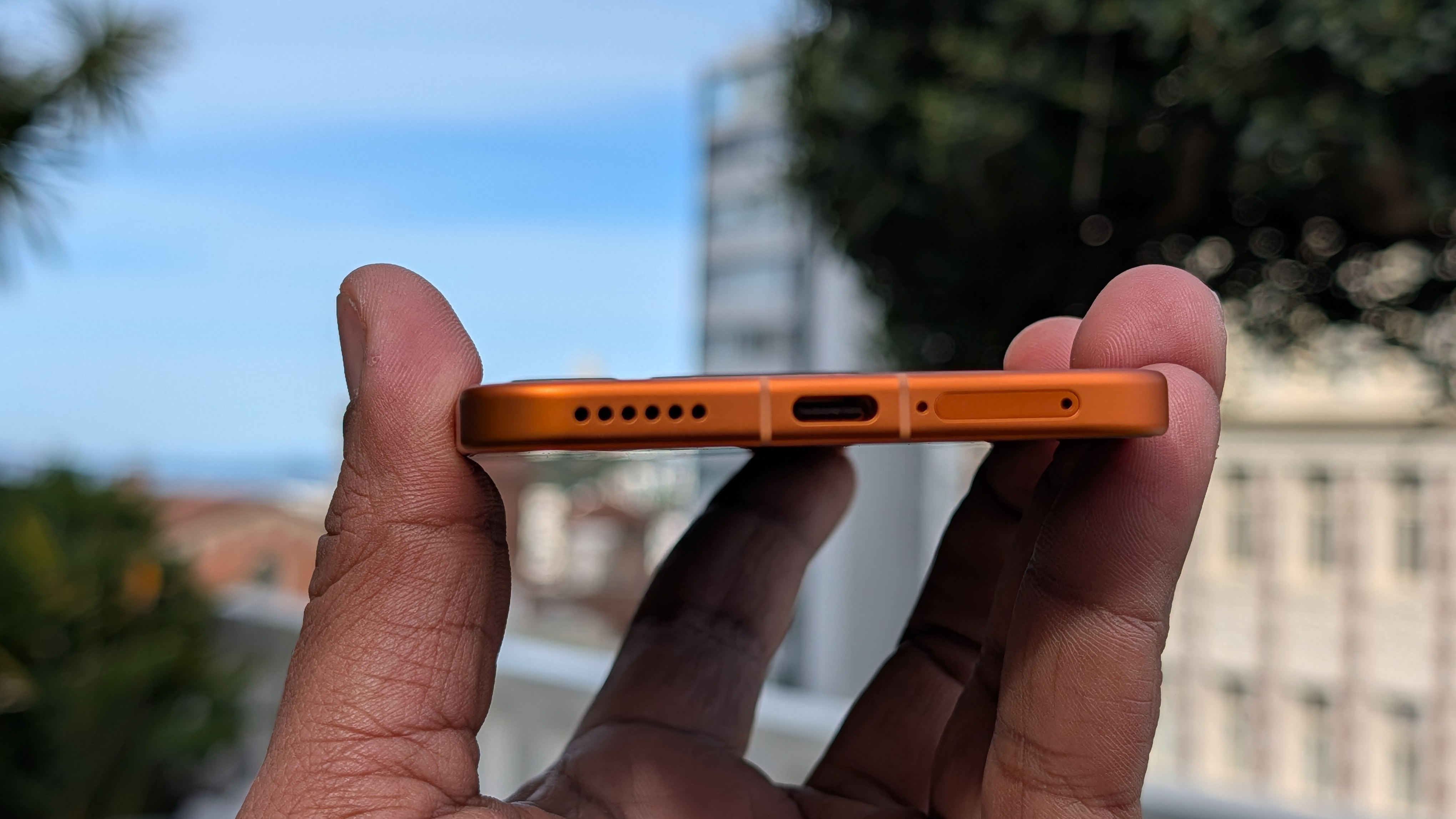 USB-C port on the Honor Magic 8 Pro Air in orange in the hand