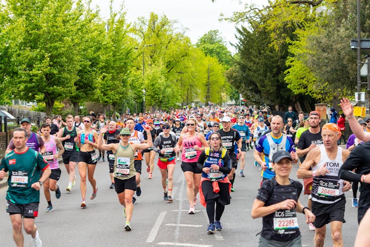 Groups of people running in the London Marathon.