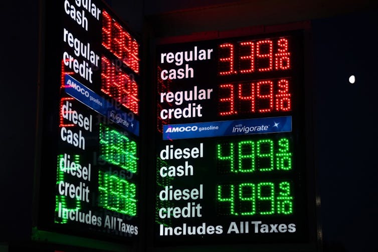 electronic display showing petrol and diesel prices at a new york filling station.