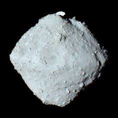 A box-shaped asteroid, covered in small rubble.