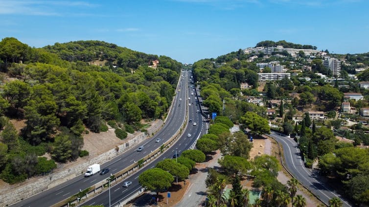 A large French road, with trees nearby.