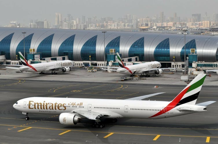 Emirates plane taxis to a gate at Dubai International Airport in Dubai