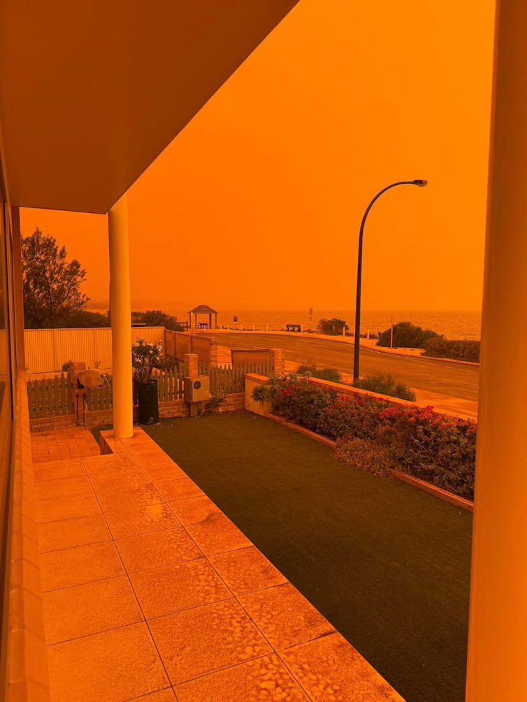 An orange-coloured picture of a verandah and the sky.