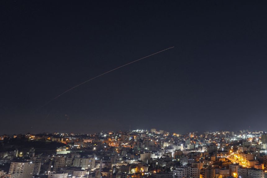 Rocket trails are seen in the sky above the city of Hebron, in the Israeli-occupied West Bank, amid a fresh barrage of Iranian missile attacks on March 4, 2026.