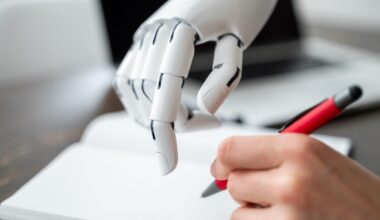 A white robot hand guides a human hand to help them write.