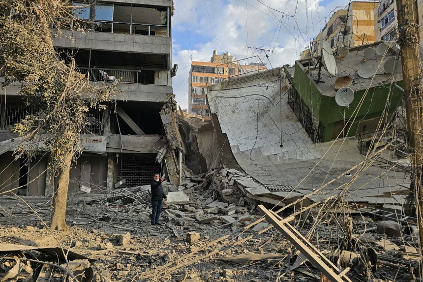 A man inspects the debris of destroyed buildings at the site of an Israeli airstrike that targeted Haret Hreik neighbourhood in Beirut's southern suburbs on March 7, 2026.