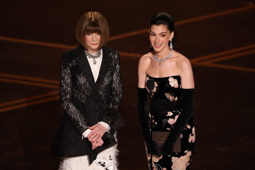 Anna Wintour, left, dropped her sunglasses (for a while) to present at the Oscars alongside Anne Hathaway.