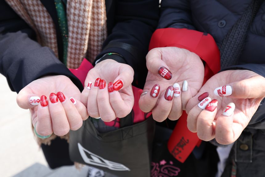 BTS fans attending the weekend concert painted their nails red and white, the primary colors of the band's new album.