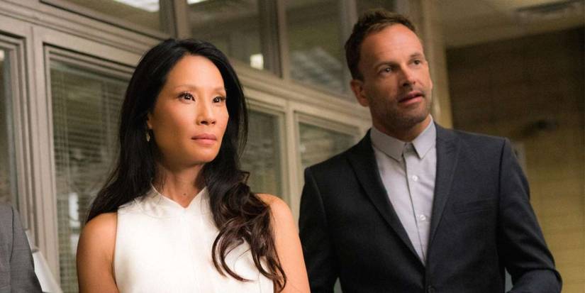 Jonny Lee Miller and Lucy Liu as Sherlock Holmes and Watson in Elementary.
