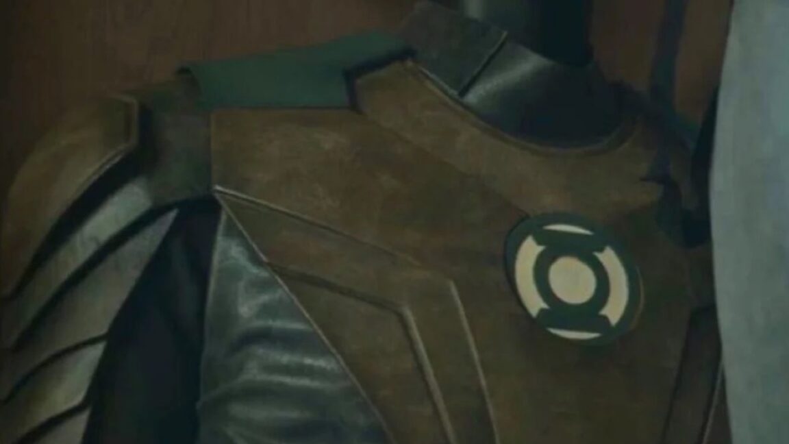 shot of a Green Lantern suit hanging in a closet with the lantern logo visible on the front.