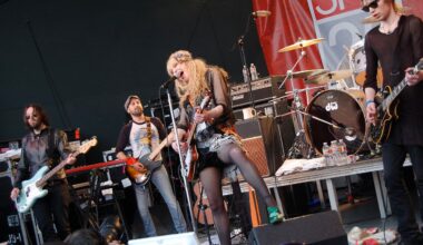 HOLE performing on stage during their SXSW 2010 concert in Austin, Texas, with band members playing guitars and drums under stage lights.