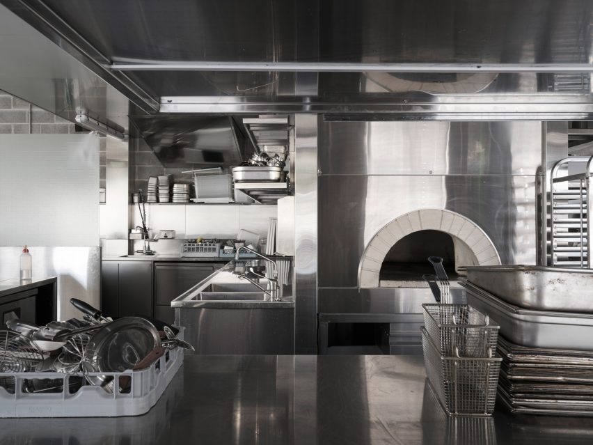 Restaurant kitchen with white brick pizza oven