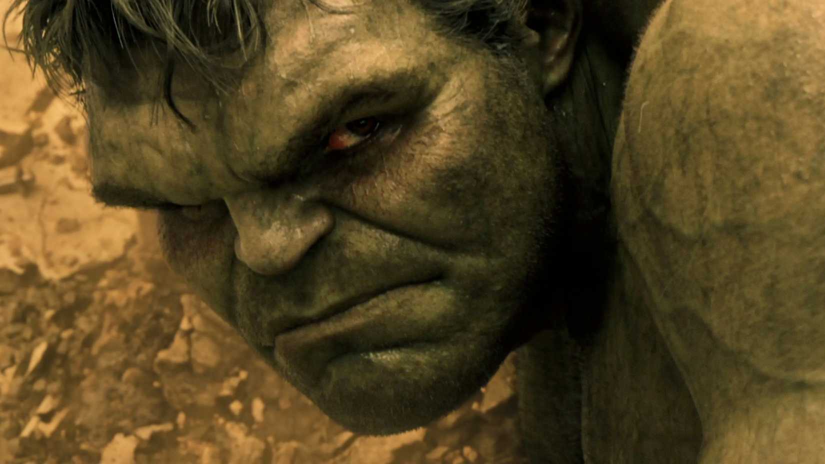 Hulk looks over his shoulder on the ground in Avengers Age of Ultron