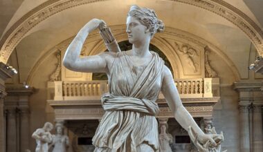 a statue of a female figure holding a quiver of arrows