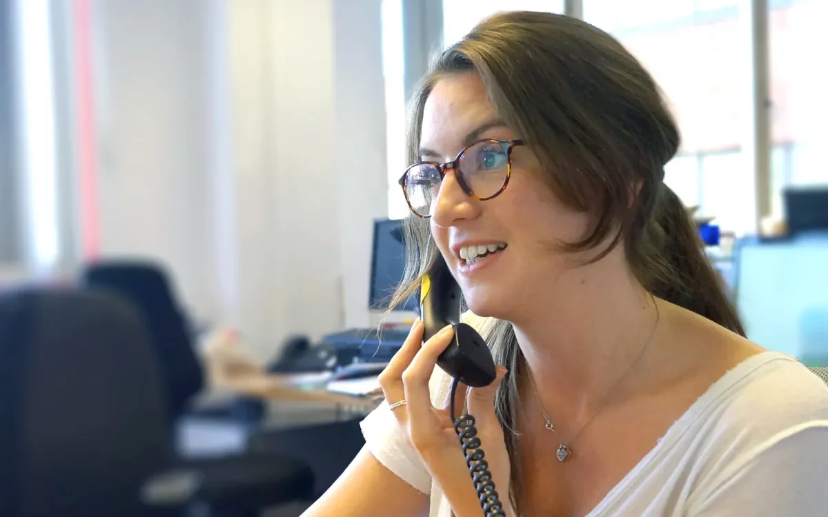 A support worker for The Brain Tumour Charity speaks on the phone
