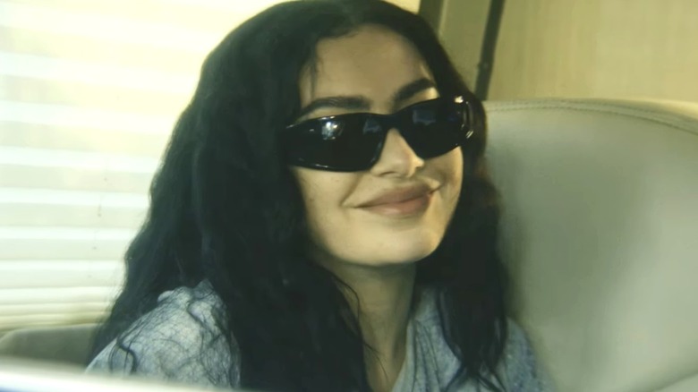 Charlie XCX smiles while playing a fictionalized version of herself in The Moment