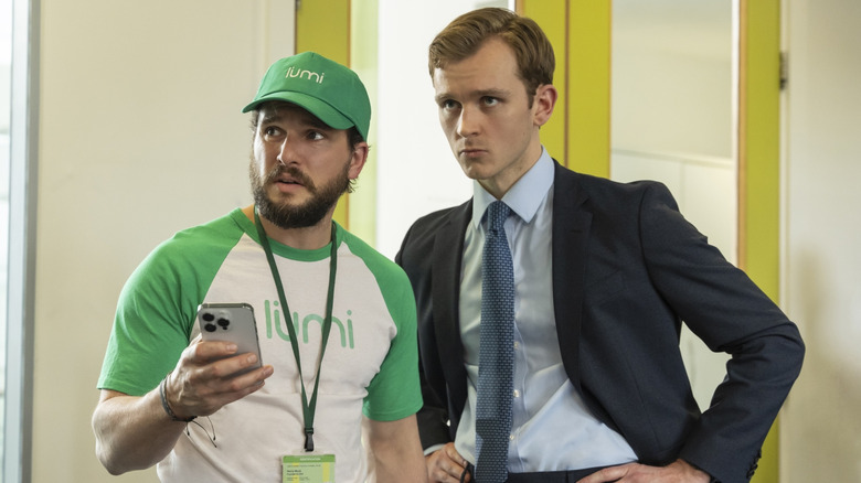 Kit Harington as Henry Muck and Harry Lawtey as Robert Spearing standing together in Industry