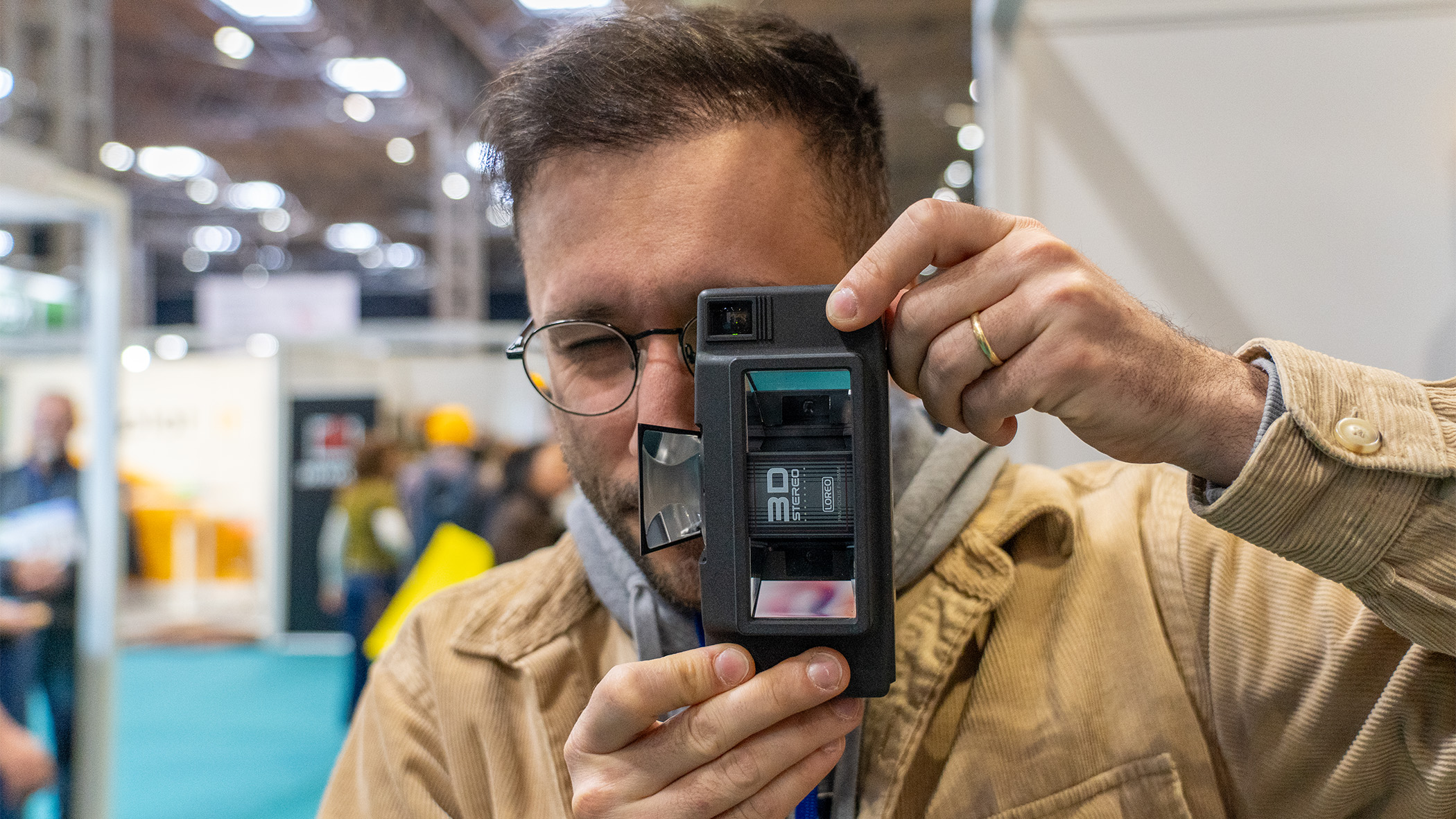 A man uses a film camera.