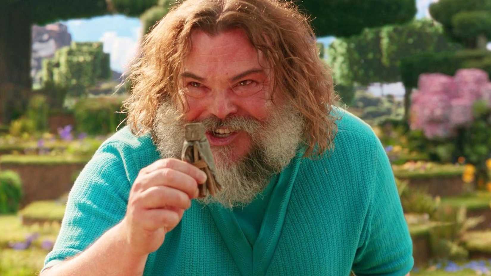 Jack Black as Steve excitedly holding up a small object in A Minecraft Movie 2025