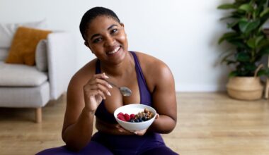 woman eats a bowl of yoghurt and fruit post workout