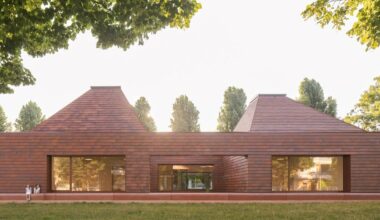 terracotta-tiled pyramidal houses envelope kindergarten in italy