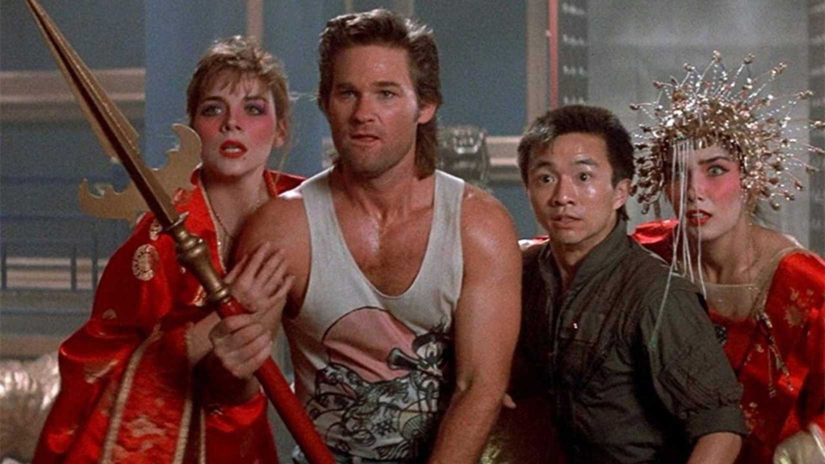 Kurt Russell as Jack Burton standing next to Wang, Gracie, and Miao Yin holding a spear in Big Trouble in Little China