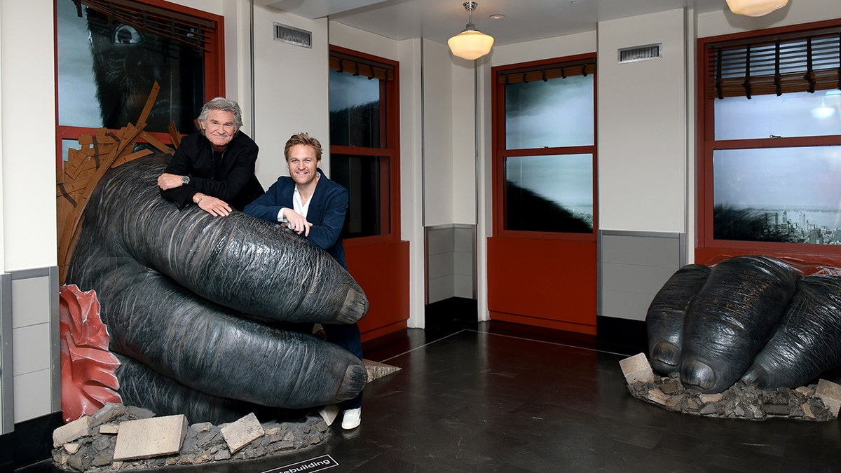 Kurt and Wyatt Russell being held by King Kong on top of the Empire State Building.