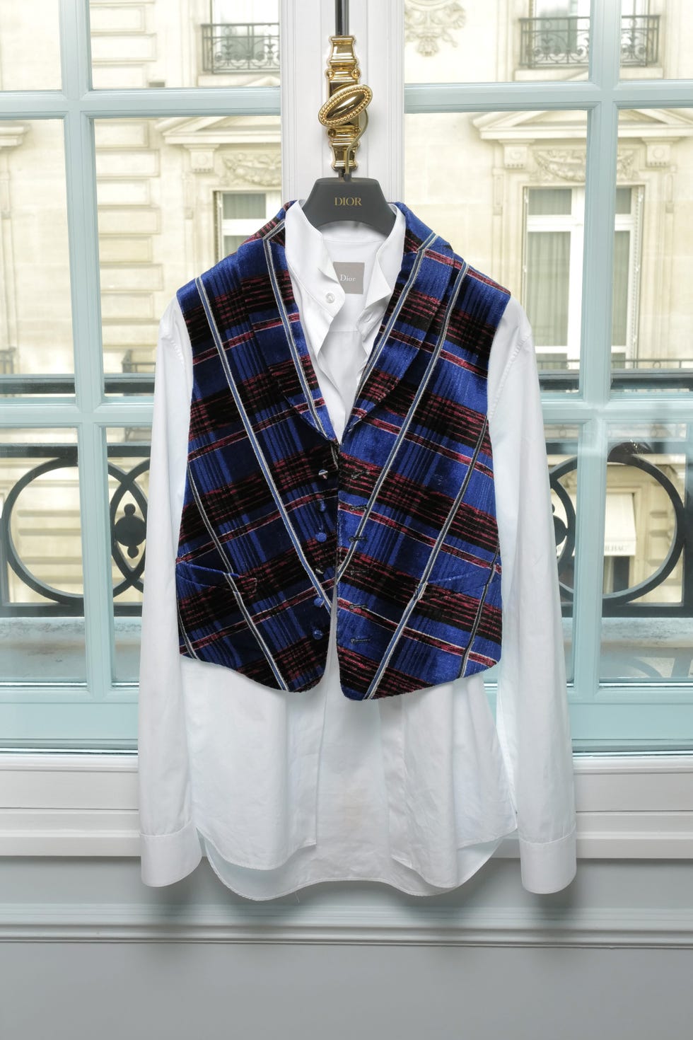 stylish vest and shirt displayed against a window