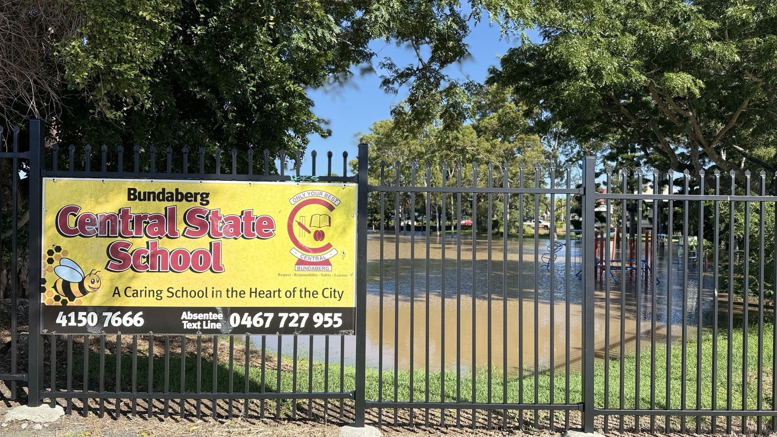 the front gate of a school with a sign reading bundaberg central state school