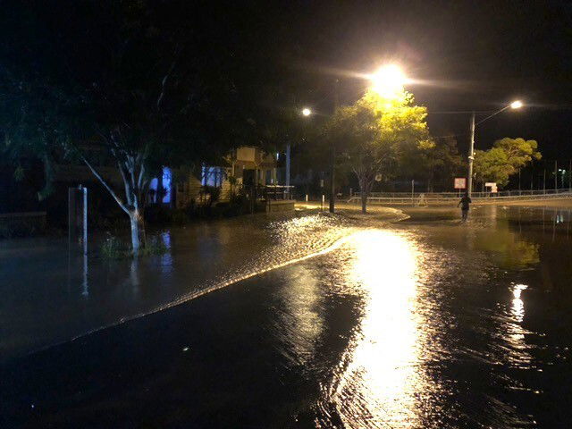 A flooded street at night 