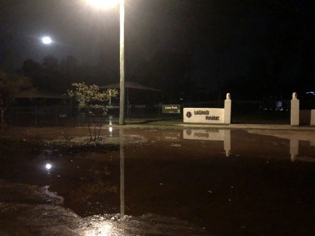 A flooded street at night 