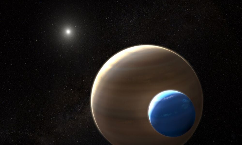 This artist's illustration shows the exoplanet Kepler-1625b and its potential exomoon, Kepler-1625b-i. This is the first exomoon candidate ever detected, and observations show it's about the same mass as Neptune, while the planet has several Jupiter masses. It's not a free-floating system and the star is in the background. Image Credit: By ESA/Hubble, CC BY 4.0, https://commons.wikimedia.org/w/index.php?curid=73369715
