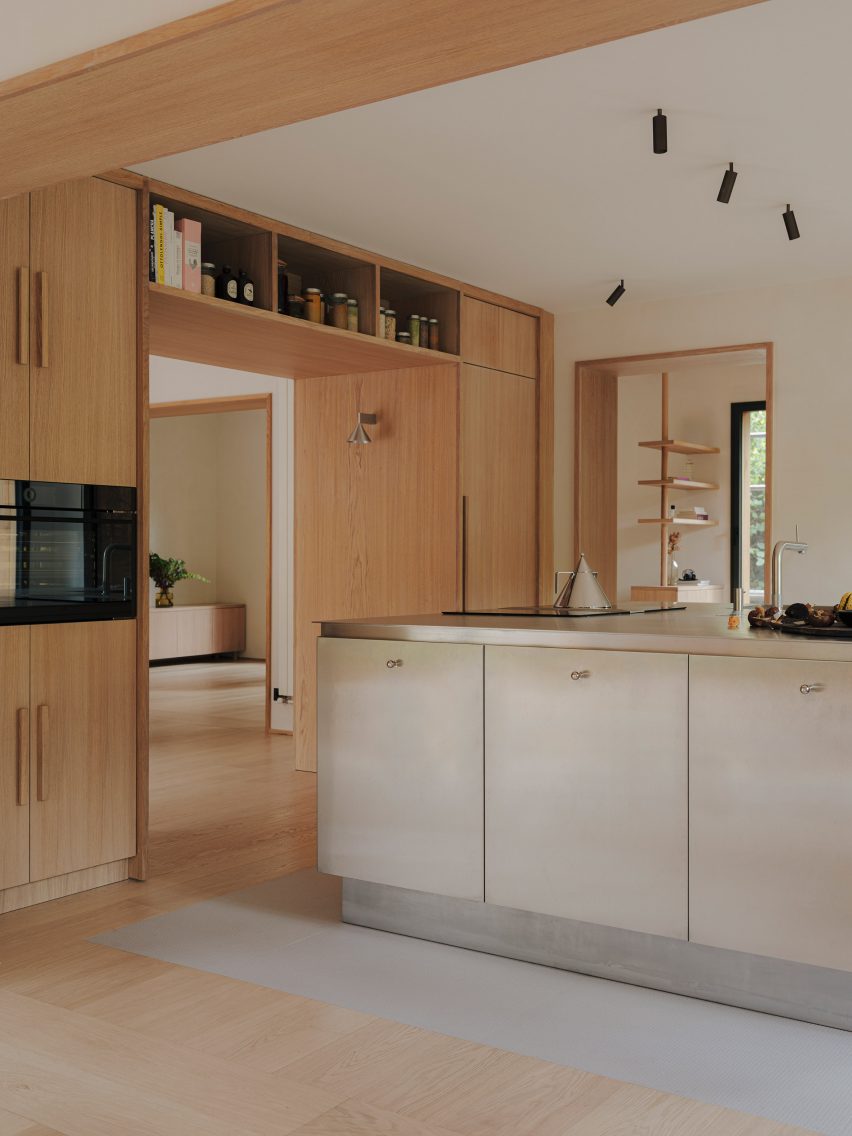 A wood-lined kitchen with stainless steel island