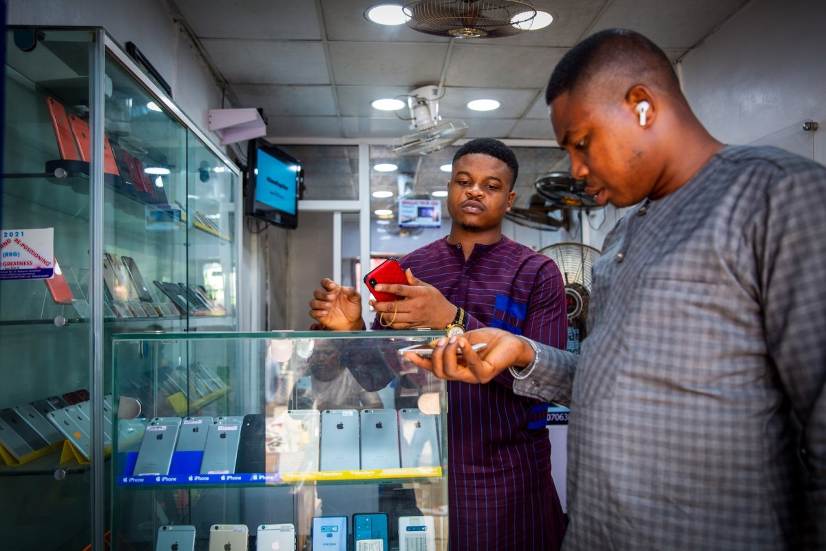 A customer browses mobile phone handsets inside a shop at the Ikeja computer village market in Lagos, Nigeria, on Monday, March 29, 2021.