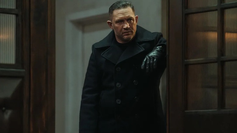 Tom Hardy as Harry leaning against a wall in MobLand