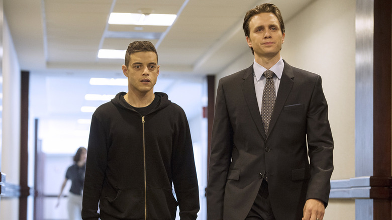 Rami Malek as Elliot Alderson and Martin Wallström as Tyrell Wellick walking together in Mr. Robot