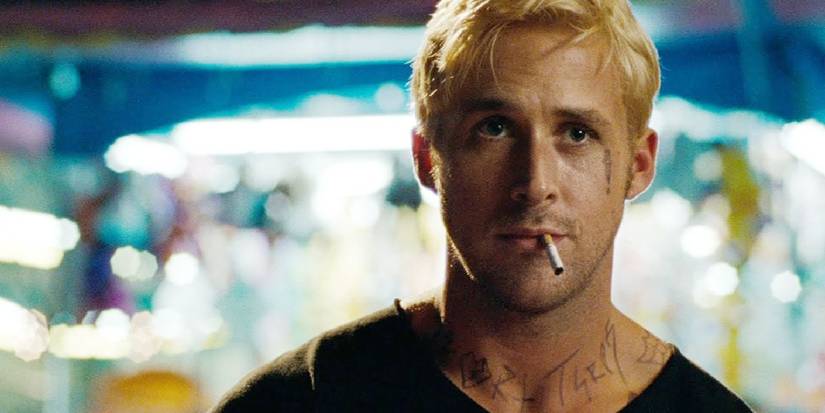 Ryan Gosling as Luke Glanton in stands with a cigarette in his mouth in The Place Beyond the Pines.