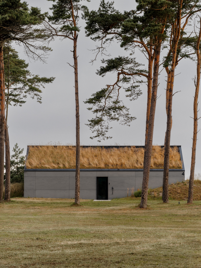grass-covered seaside family home repurposes abandoned soviet military bunkers in latvia - 3