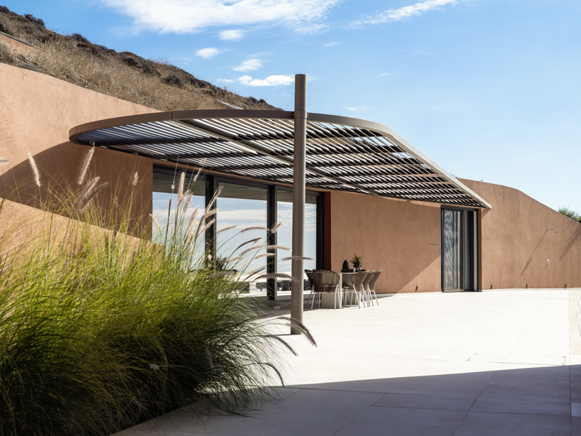 olen resort embeds into greek island slope across three terraced levels - 4