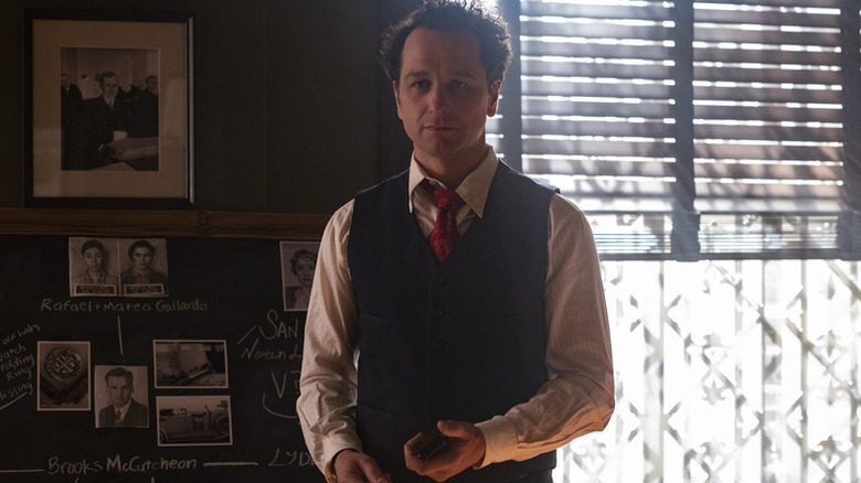 Perry Mason (Matthew Rhys) stands next to a case board in his office in Perry Mason