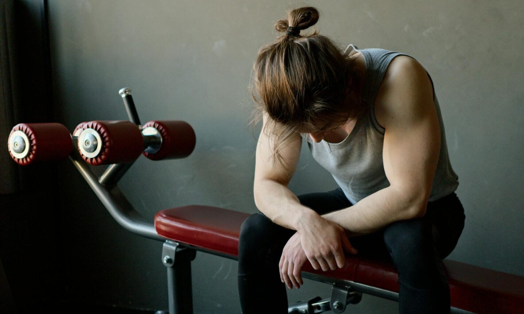 man sitting on the bench in the gym