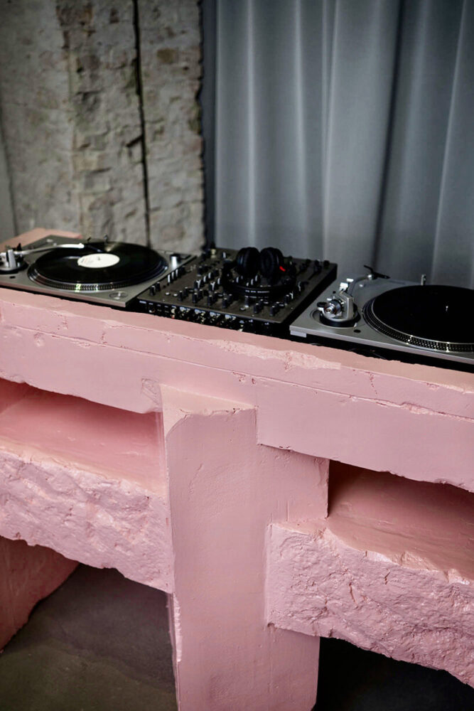 turntables and mixer integrate into the sculptural pink DJ booth | image by Mara Menzel  