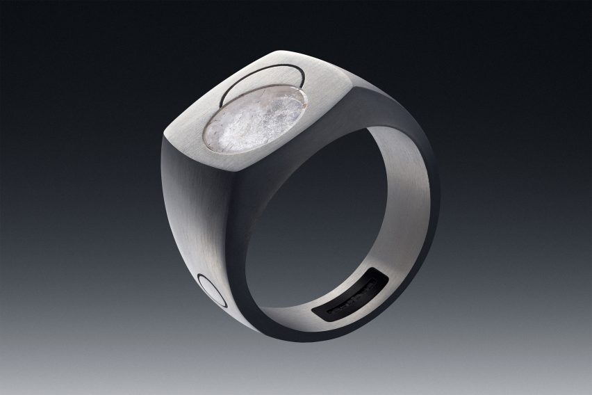Image of the Quartz ring showing a chunky, signet-style form and a circular disc of quartz stone embedded in the top along with an engraved design