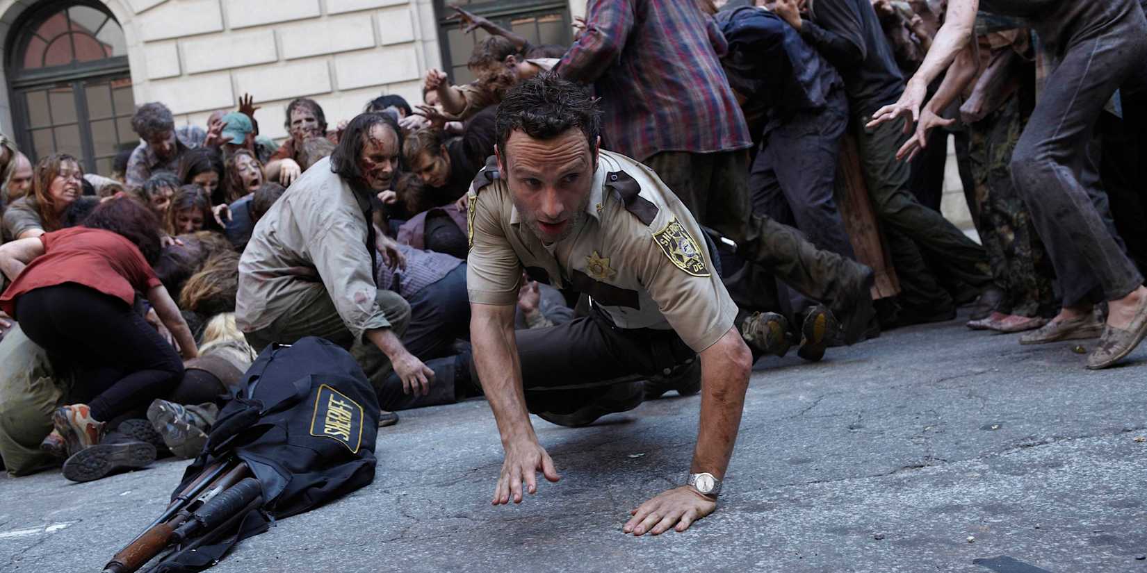 Rick being attacked by a horde in The Walking Dead pilot