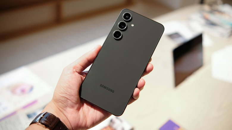 A person holding the Samsung Galaxy S24 FE at a Samsung event